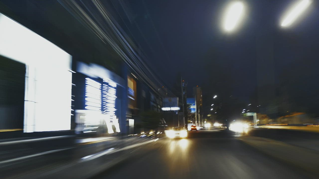 Rear view of a car through the city - Free Stock Video