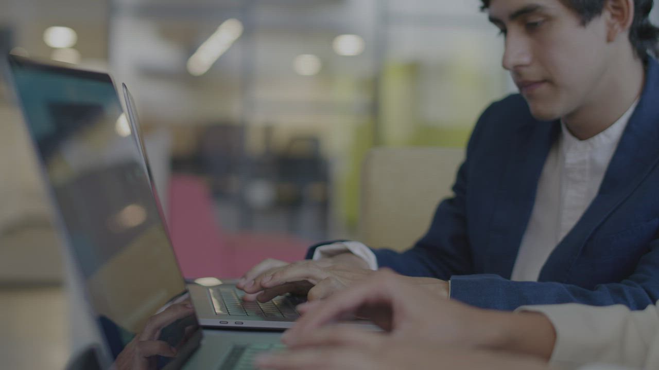 Two colleagues reviewing work together on a computer