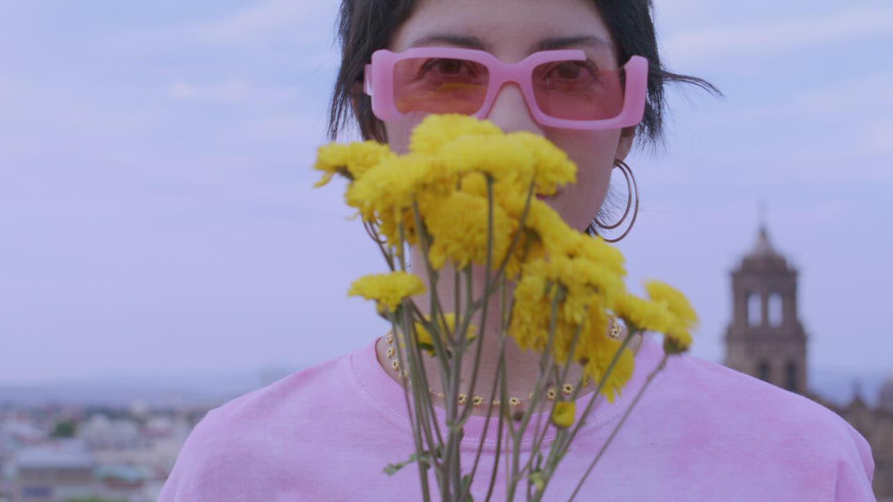 Portrait of a woman with yellow flowers - Free Stock Video