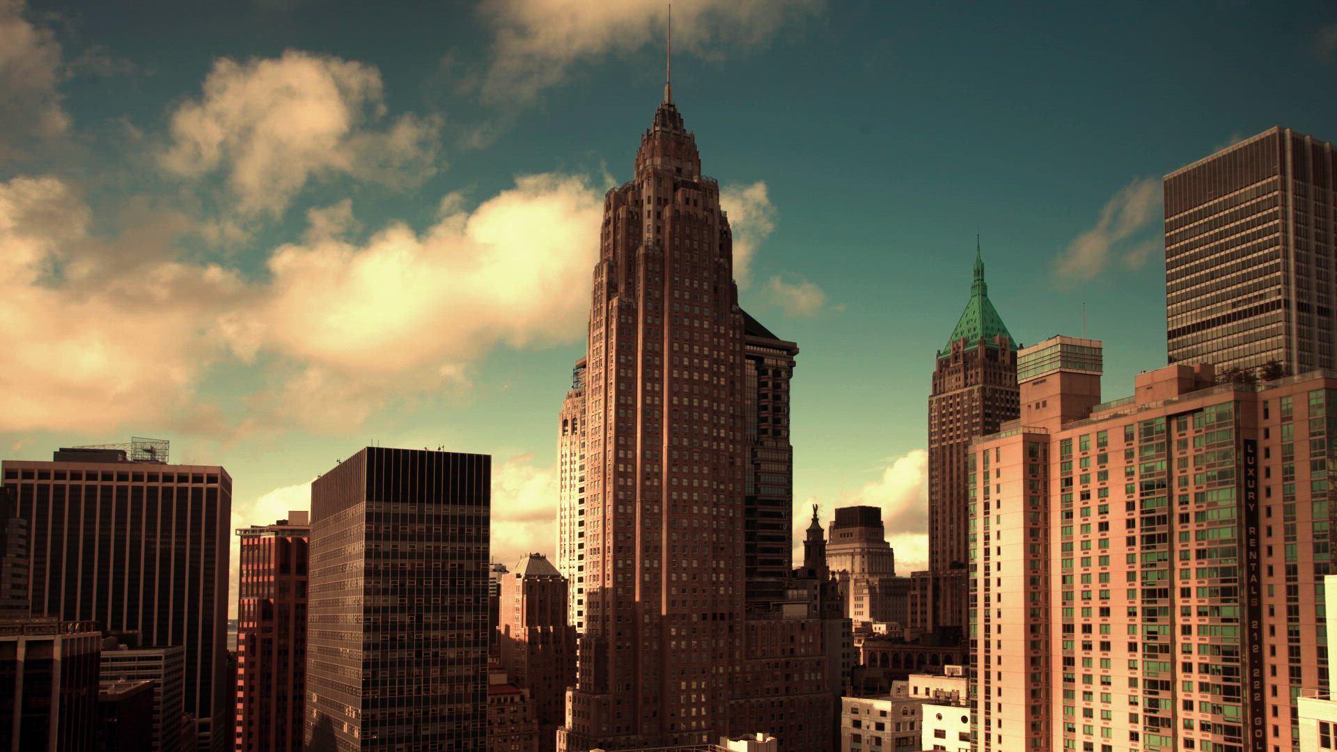 Aerial view of a city skyline of towers at golden hour