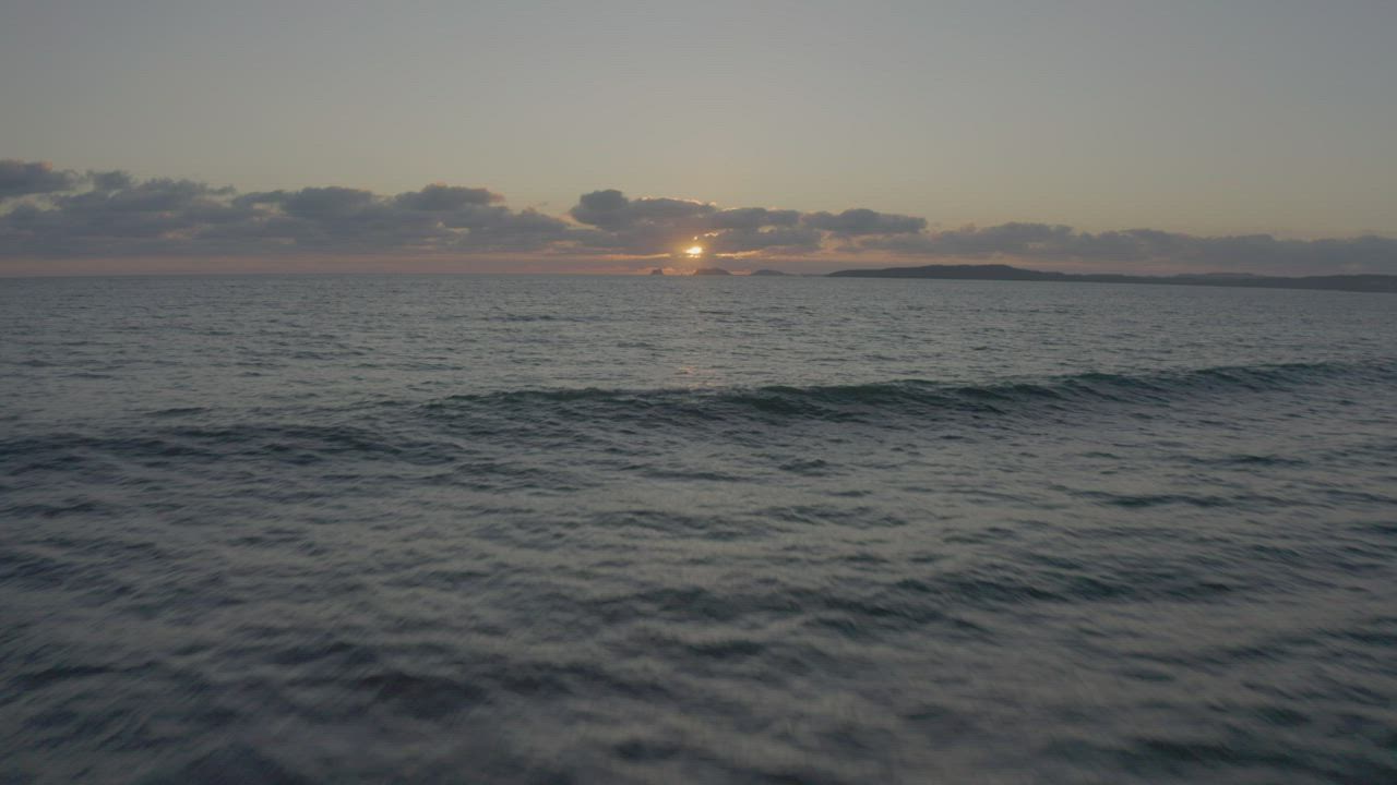 Sunset in an aerial shot over the sea - Free Stock Video