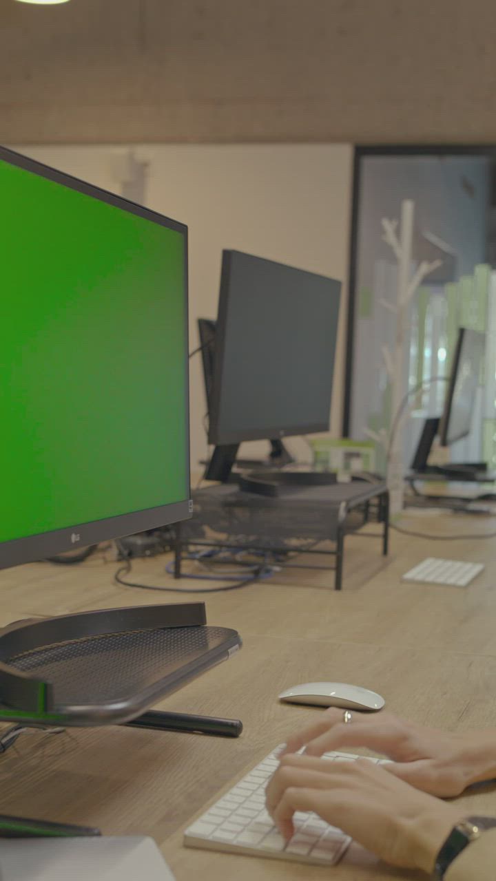 Working on a computer with the chroma green screen - Free Stock Video
