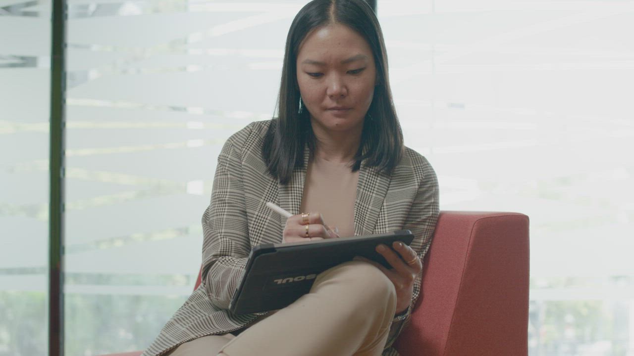 Professional woman writing on a tablet with a stylus free stock video