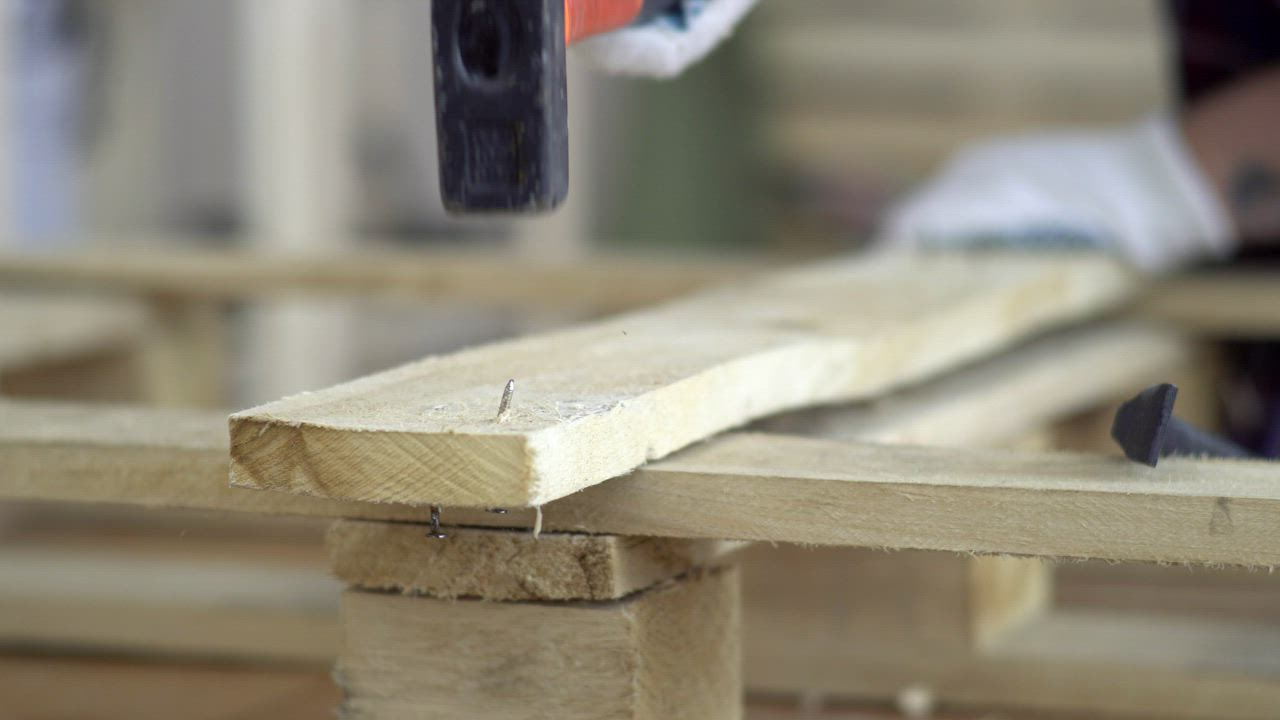 Carpenter expertly removing crooked nails from a wooden plank - Free ...