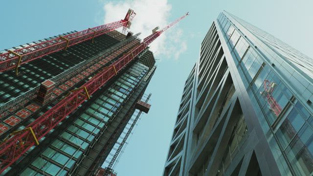 Two large buildings seen from below.