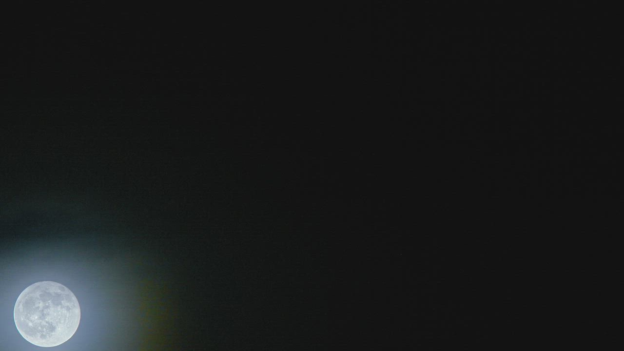 Moon rising with light cloud cover - Free Stock Video