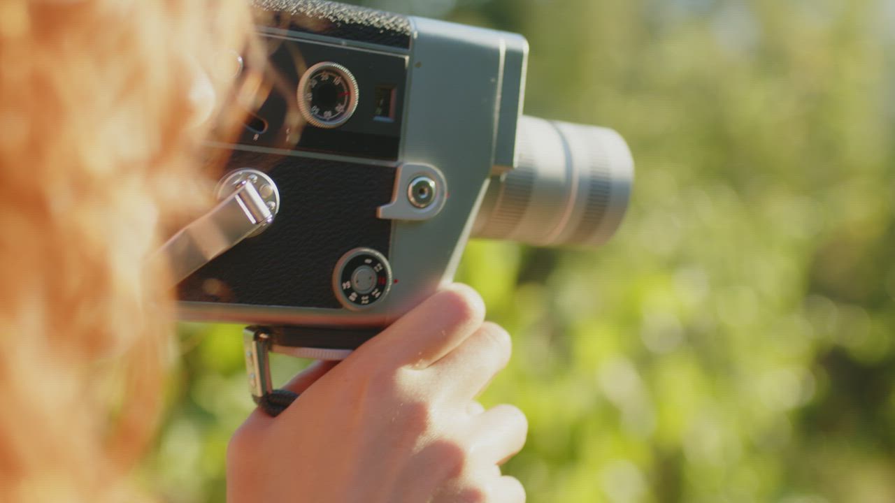 Close up of a woman filming with a vintage 8mm camera outside - Free ...