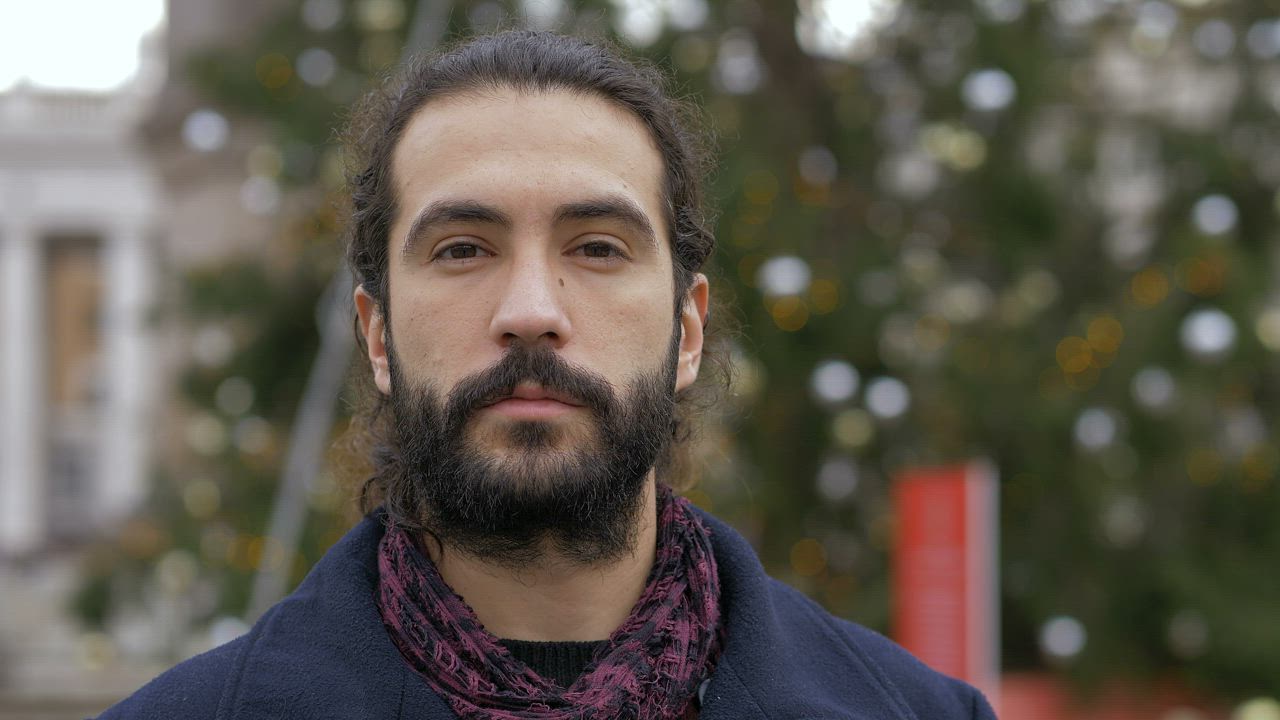 Young man with a beard standing in the snow - Free Stock Video