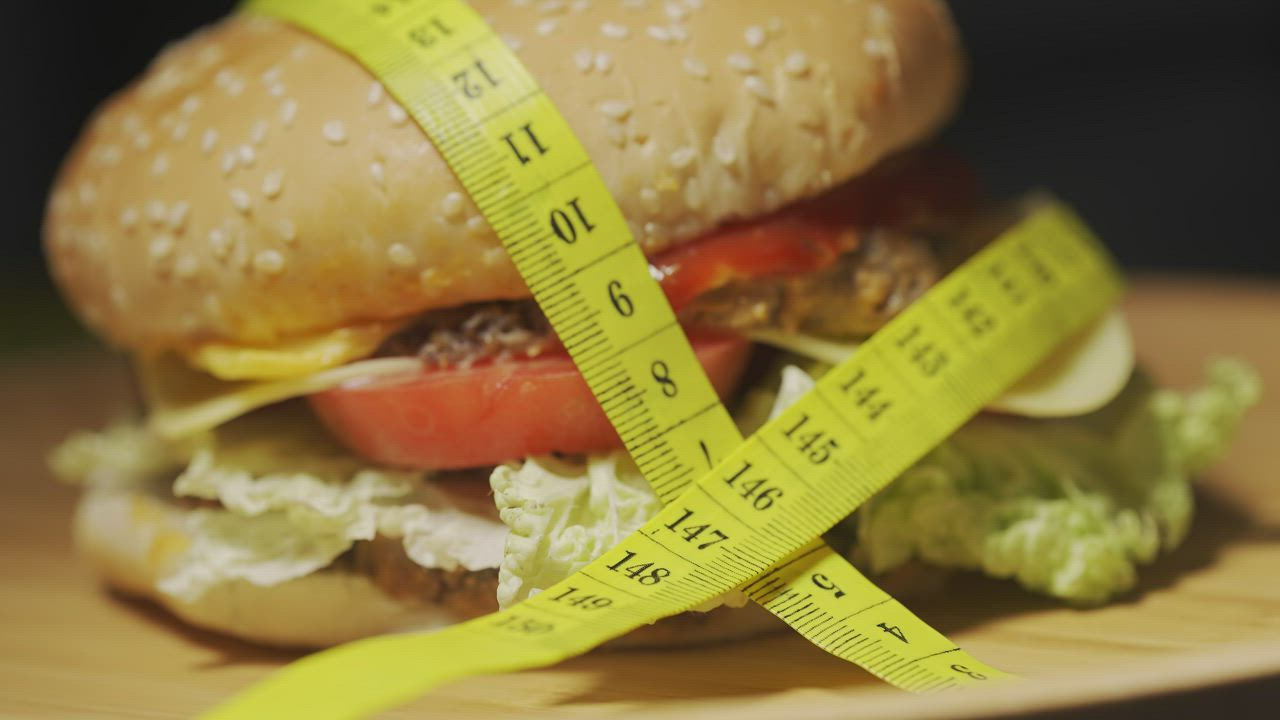 Hamburger with metric quote over a rotating dish - Free Stock Video