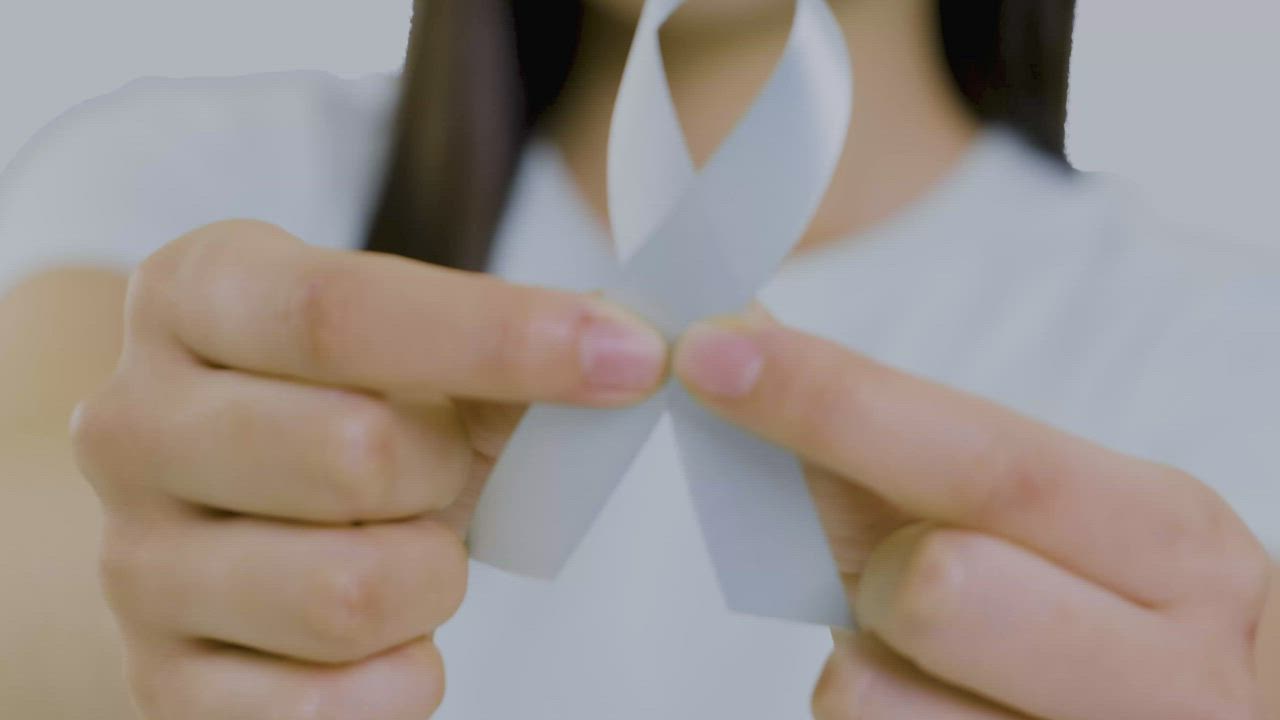 Woman with a lung cancer ribbon on her chest - Free Stock Video