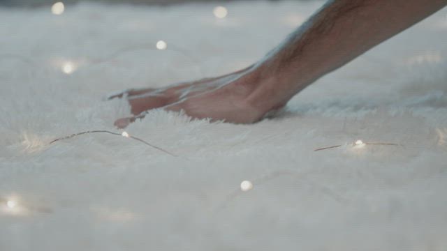 Hand touches the soft texture of the rug.