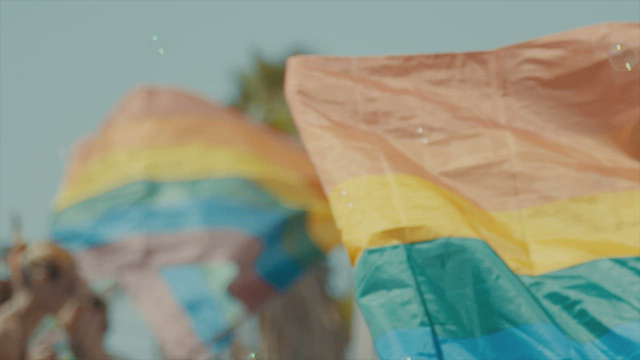 Pride flags waving during a pride parade - Free Stock Video