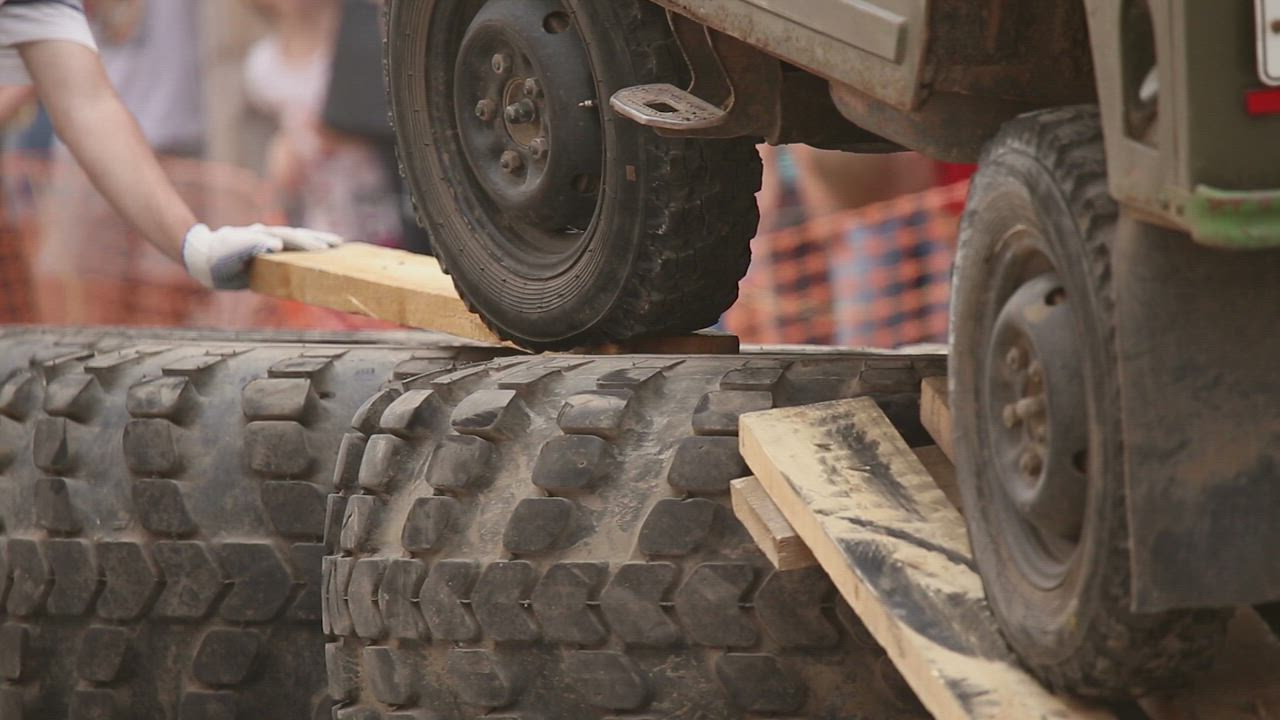Truck wheels driving over obstacles - Free Stock Video