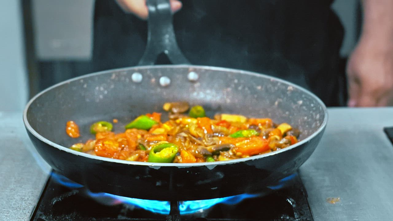 Chef cooking stir fry vegetables on high heat Free Stock Video