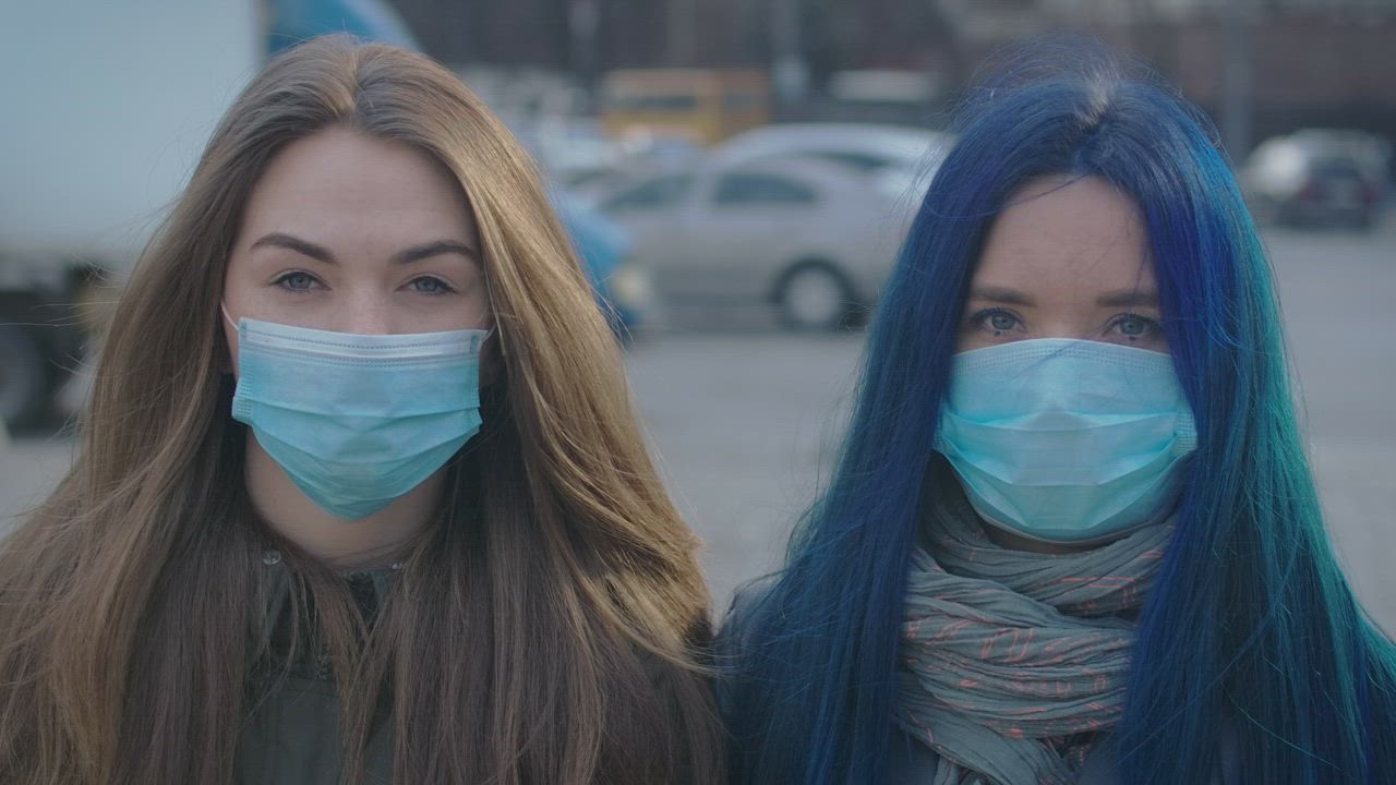 Two girls with masks on the street - Free Stock Video