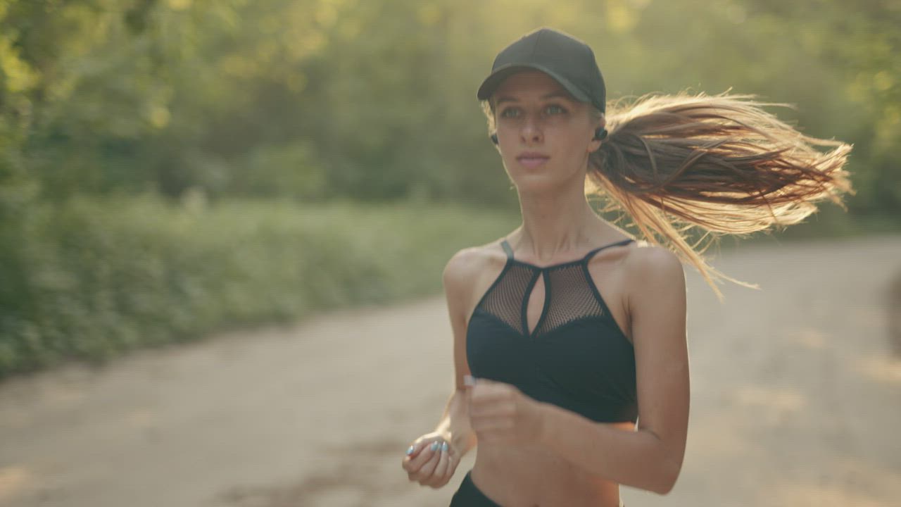 Slow motion of a girl running outdoors - Free Stock Video