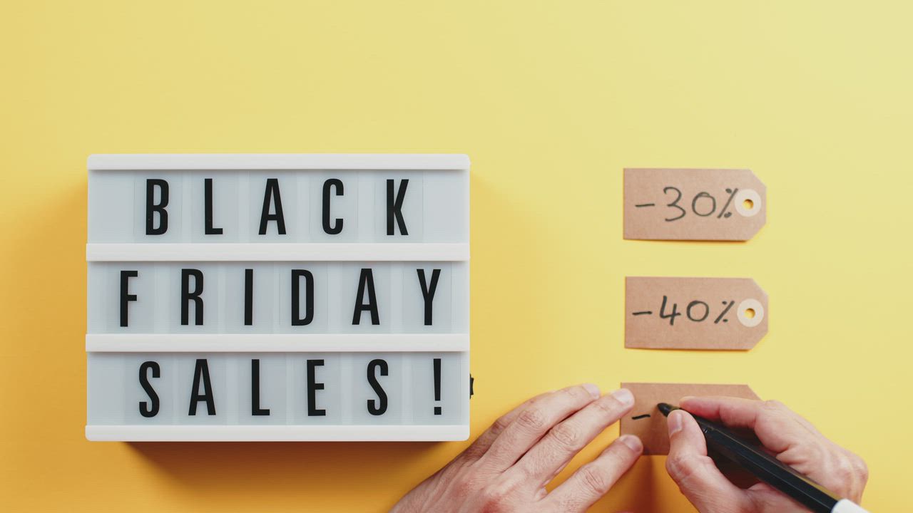 Hand listing the available black Friday discounts - Free Stock Video