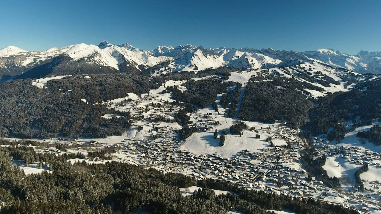 Drone view of snow covered town in the Alps - Free Stock Video