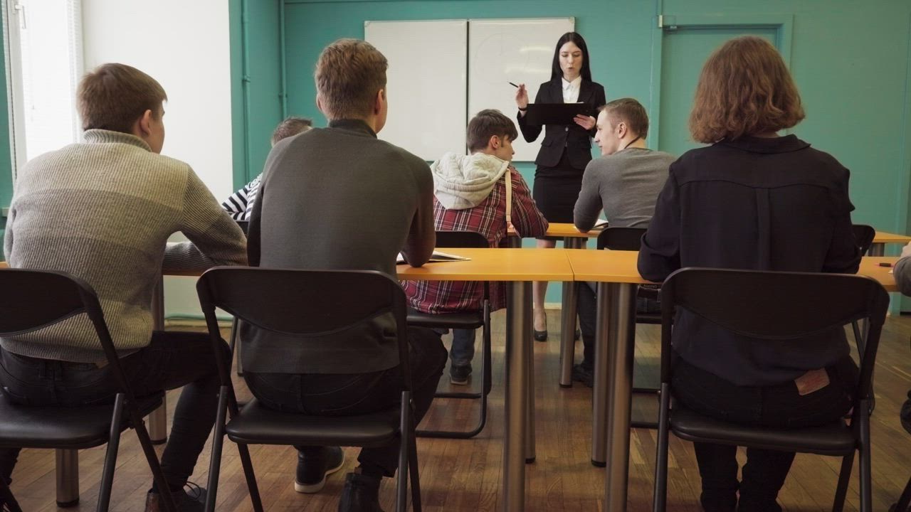 University students in a classroom with a professor - Free Stock Video