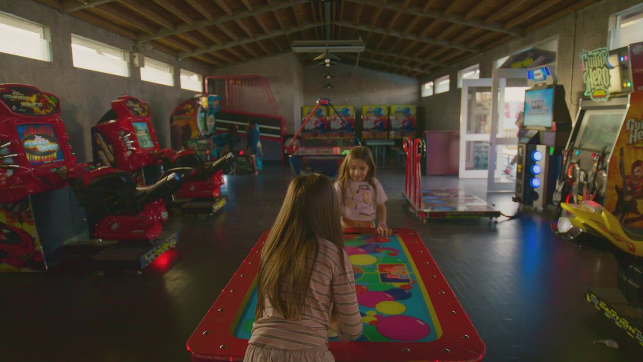 Group of kids havig fun at the arcade shop - Free Stock Video