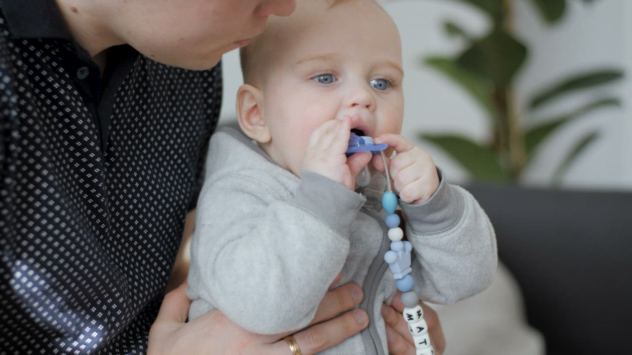 Teething baby chewing on a teething toy - Free Stock Video