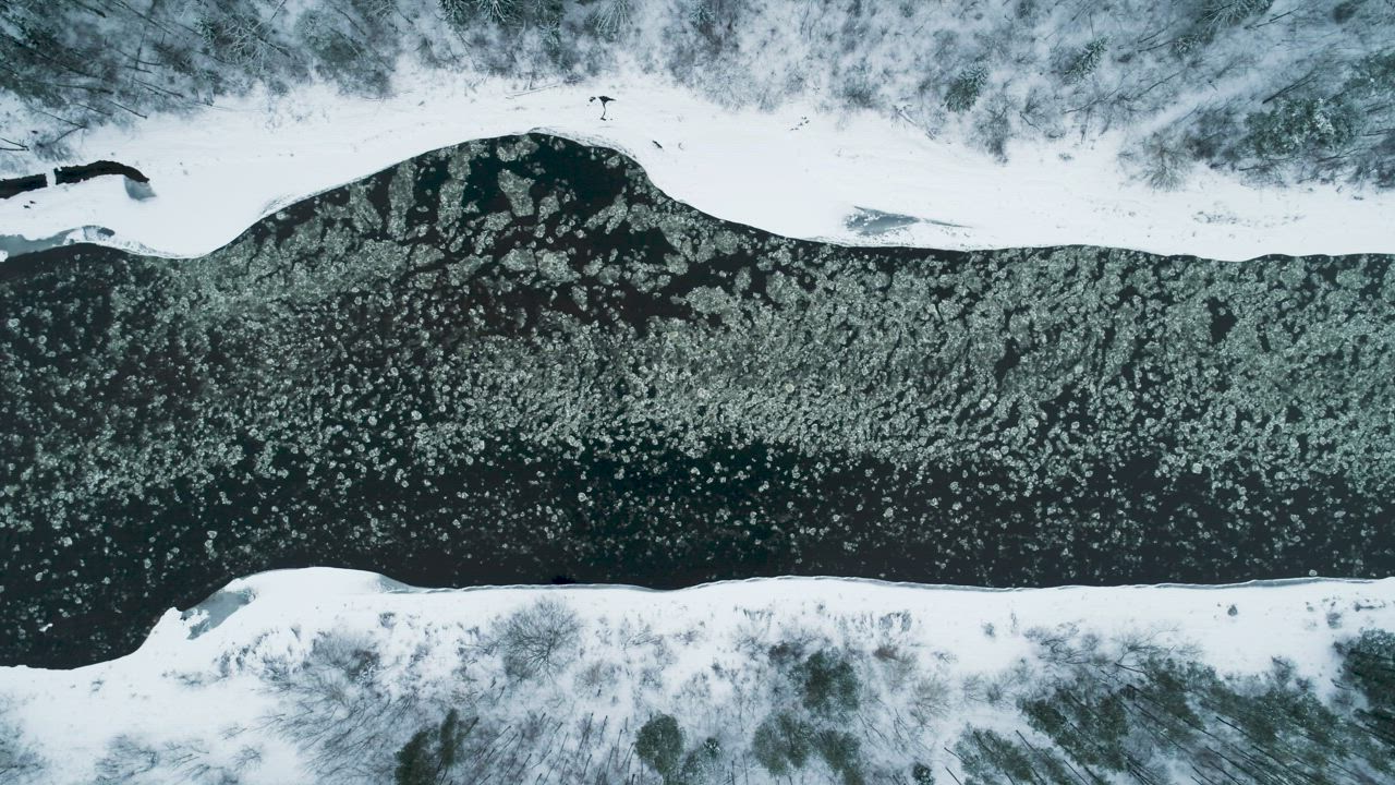 Aerial view of ice floes in a river in winter - Free Stock Video
