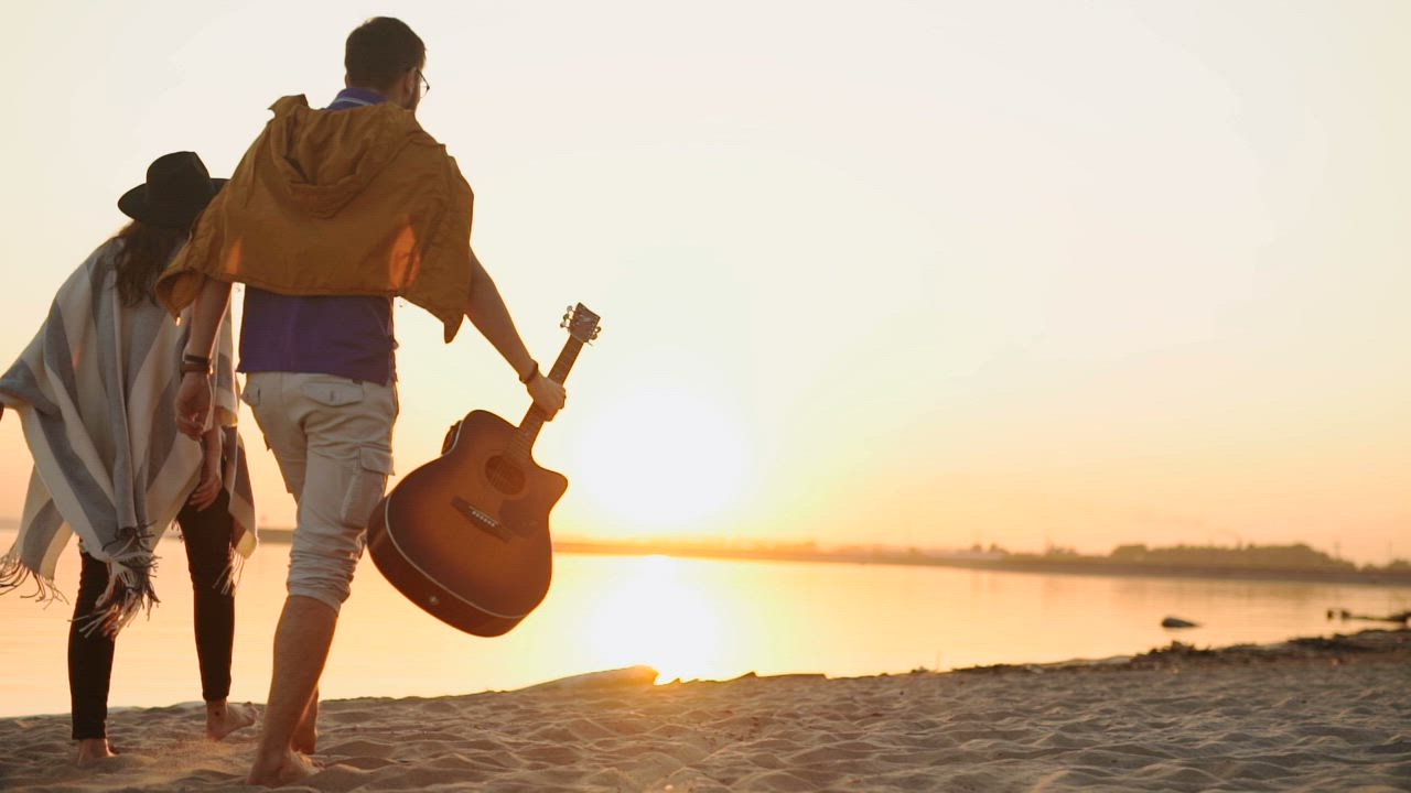 Couple enjoying a romantic walk along the beach at sunset - Free Stock ...