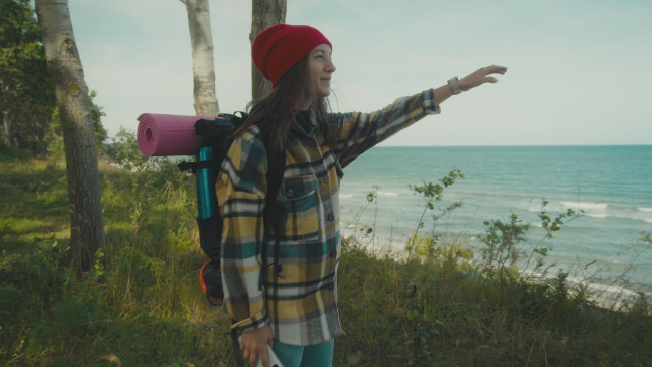 Traveler pointing out at the ocean views - Free Stock Video