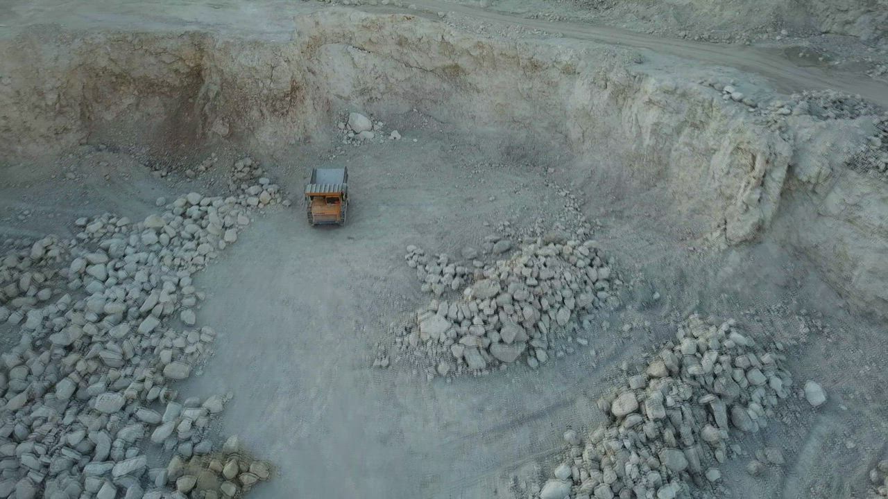 Excavation machinery operating inside an opencast mining quarry.
