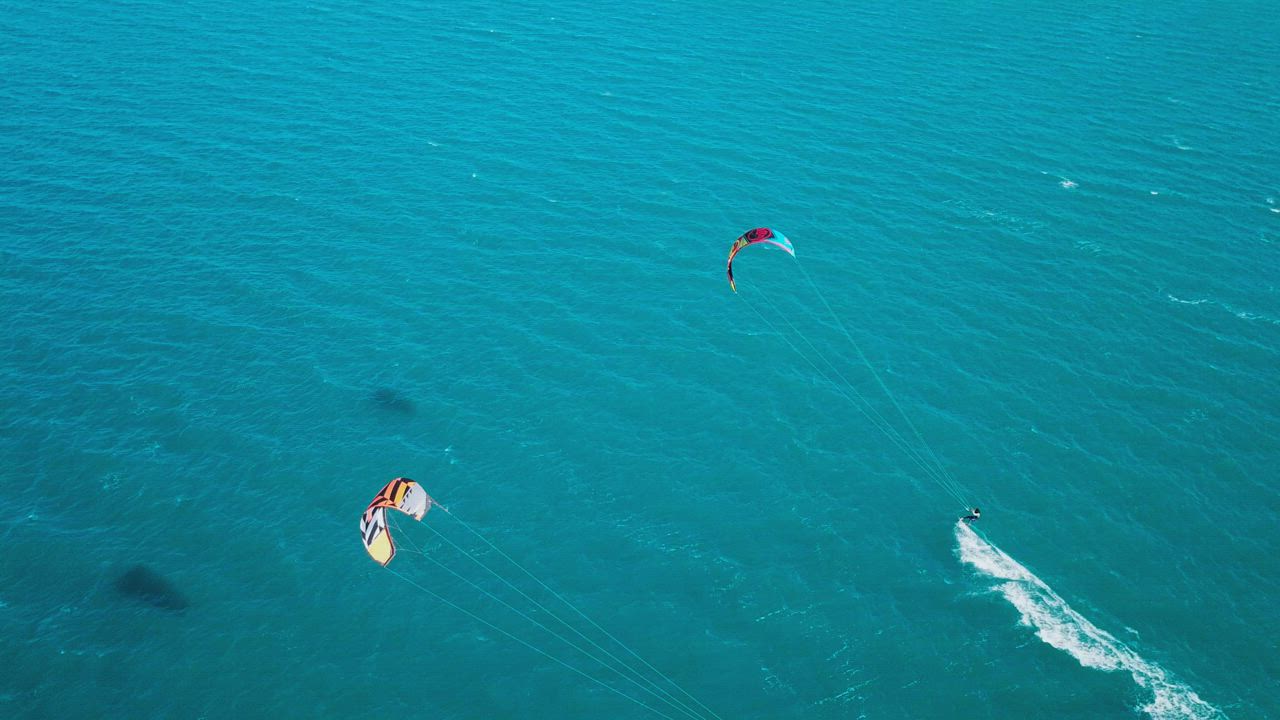 Aerial view of kite surfers riding across the Mediterranean sea - Free ...