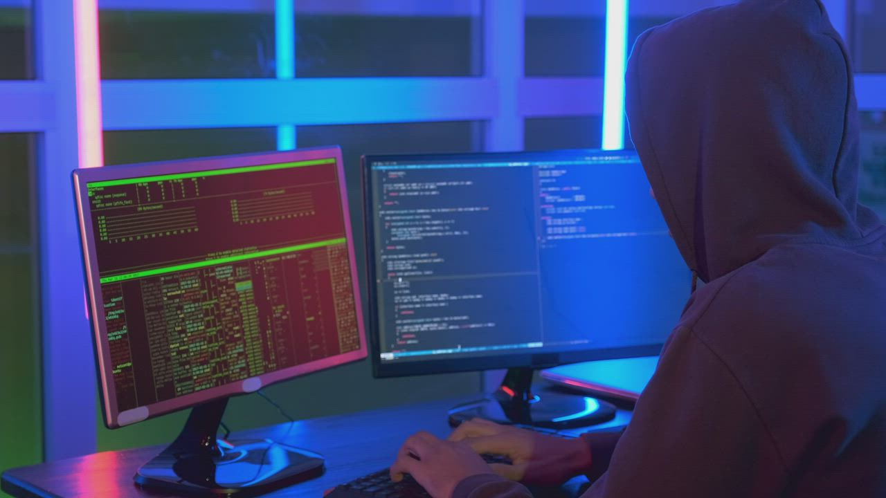 Close up of a hacker working on a computer in the dark Free Stock Video