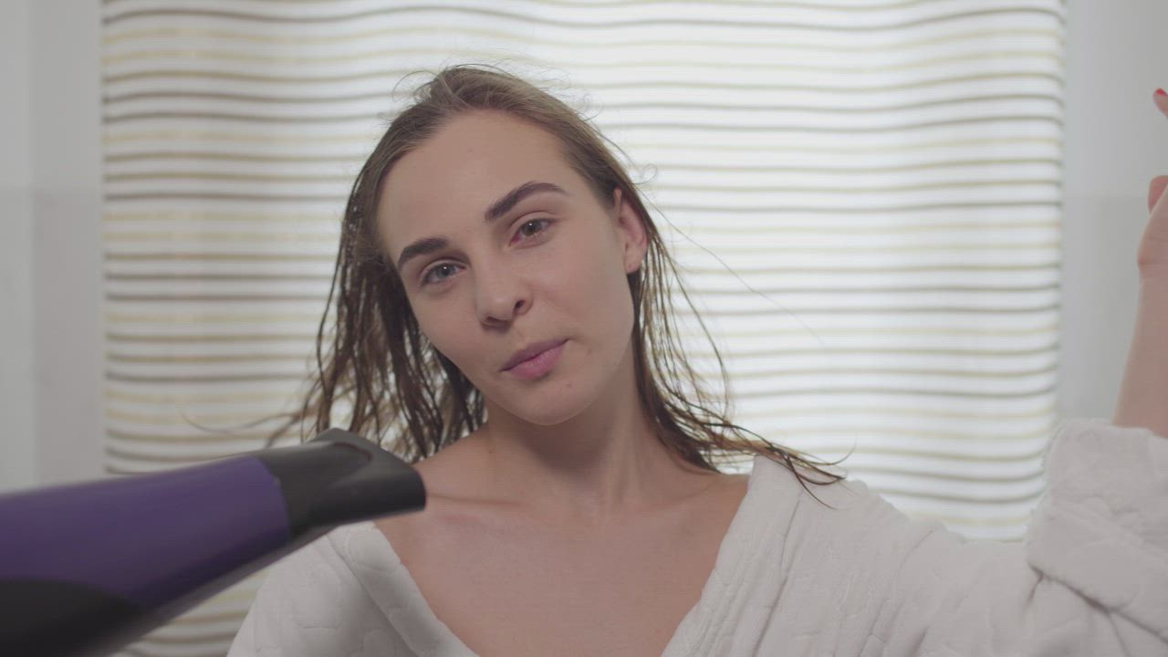 Young woman blow drier her hair as she dances facing forwards - Free ...