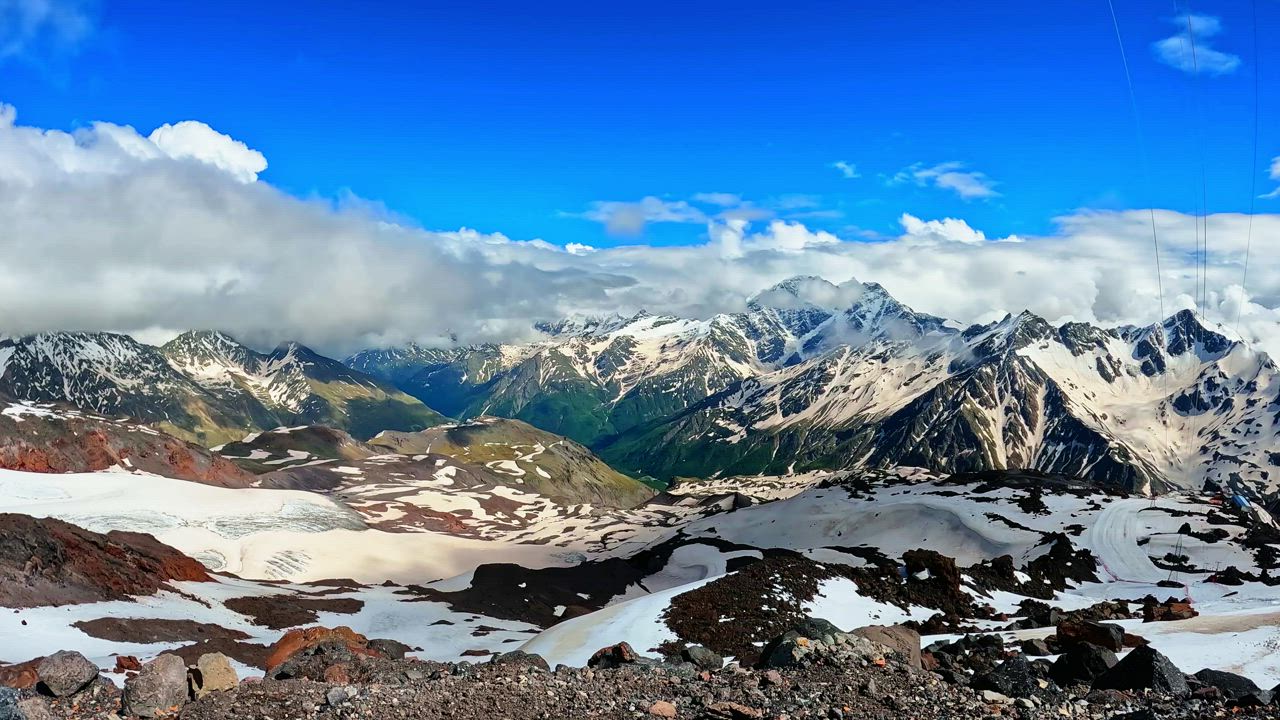 Mountain range with snow and clouds - Free Stock Video