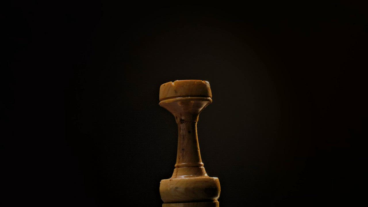 Wooden chess rook rotating on a dark background - Free Stock Video