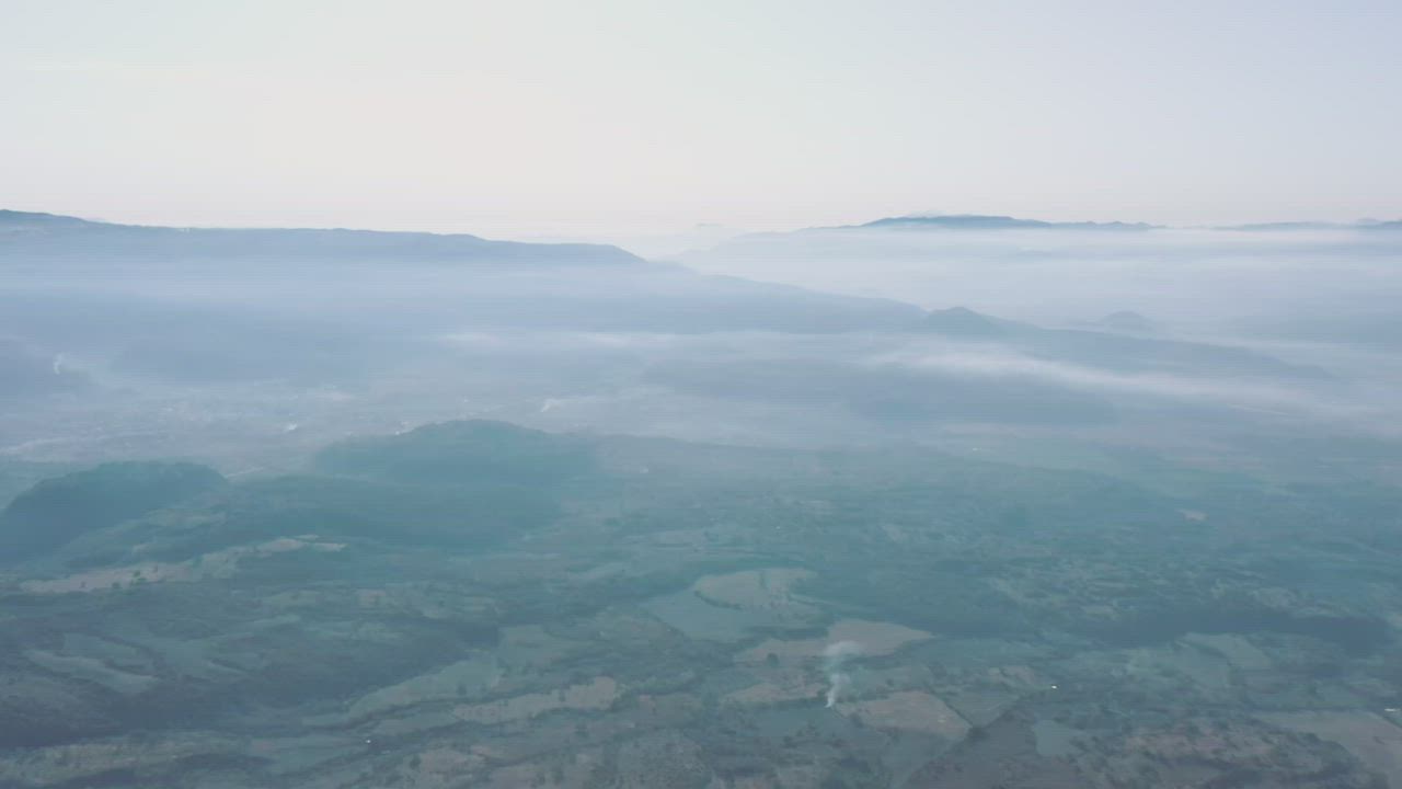 Natural landscape covered with mist in an aerial view - Free Stock Video