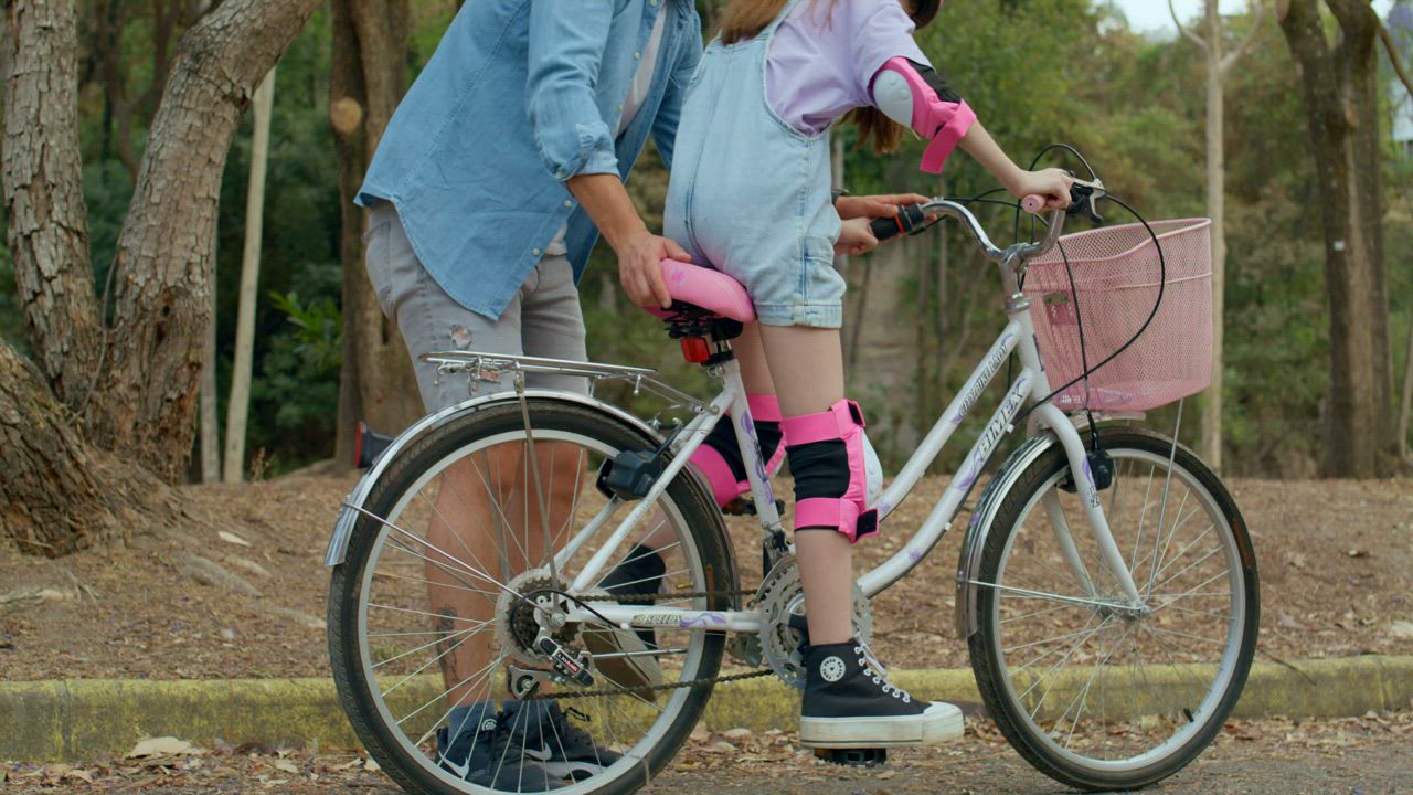 A young father imparts detailed bike riding instructions to his ...