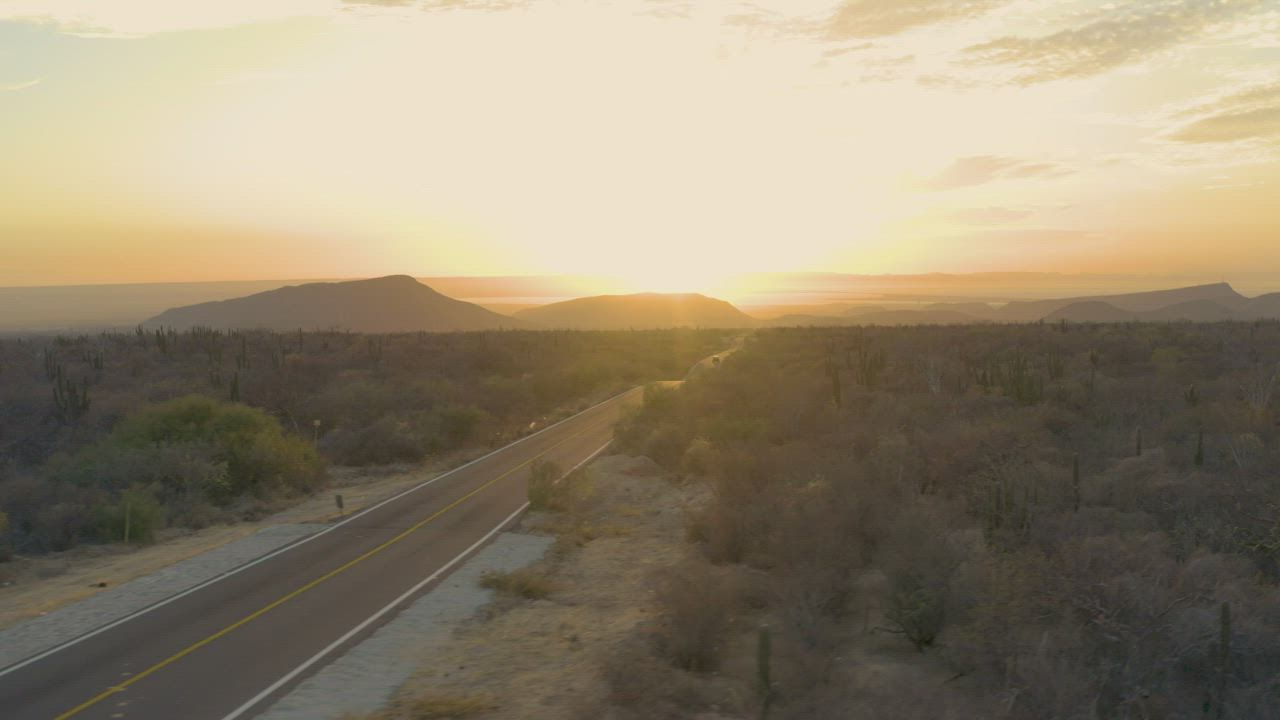 Panoramic aerial view of a natural landscape at sunset - Free Stock Video