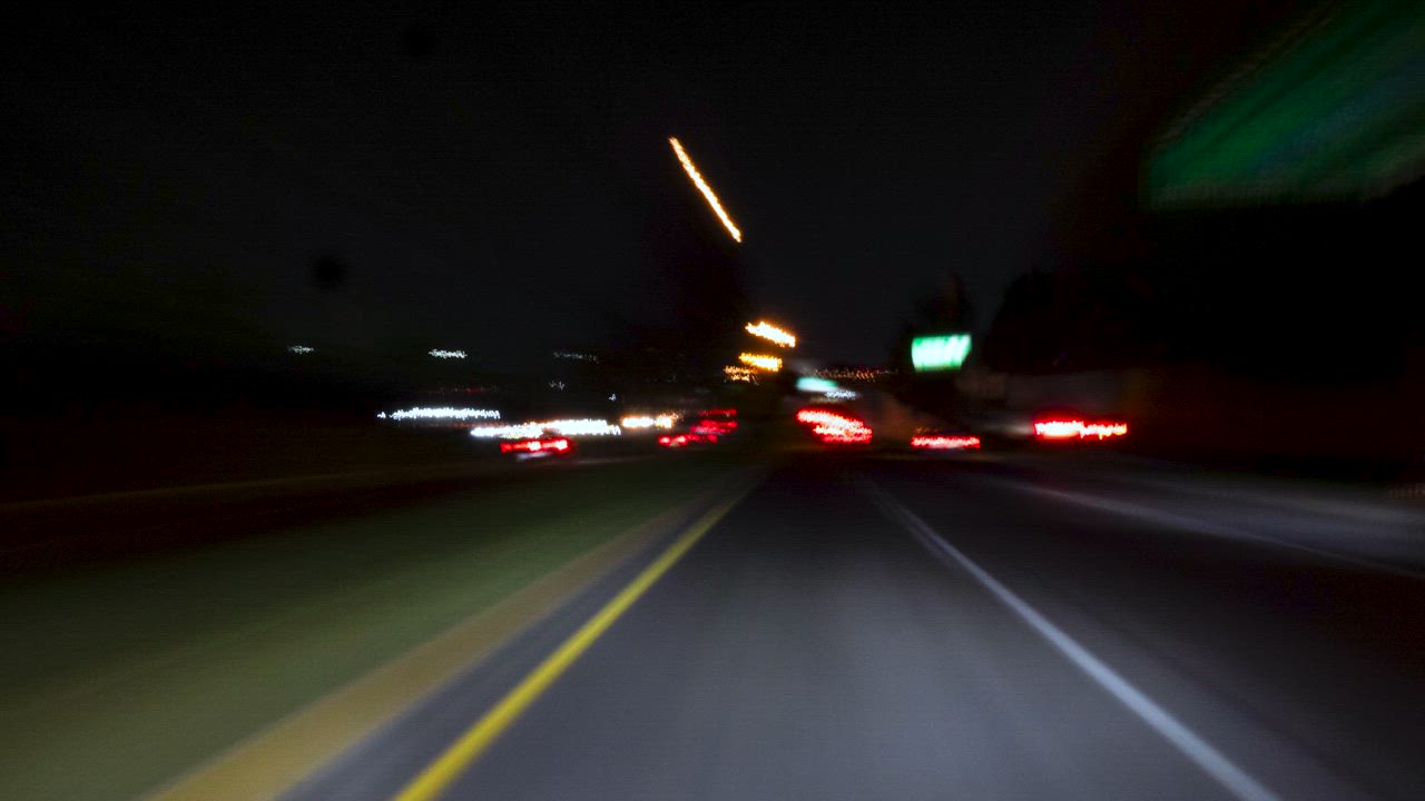 Timelapse of a car driving through the city at night - Free Stock Video