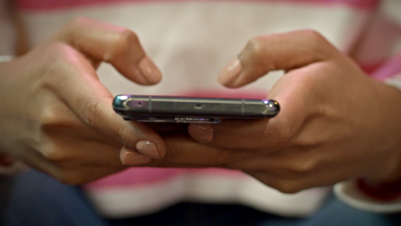 Hands holding a phone reading a text message