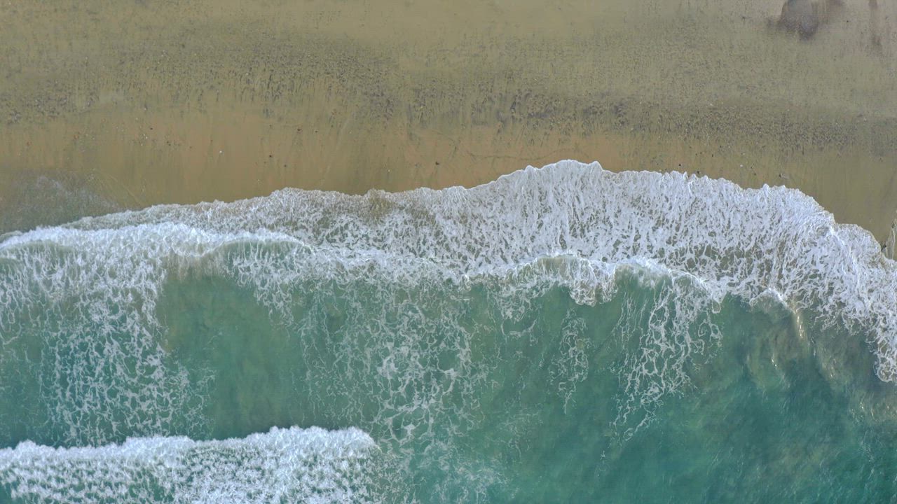 Foamy waves of sea water reaching the beach - Free Stock Video