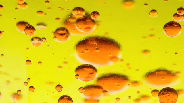 Texture of a bright yellow viscous liquid.