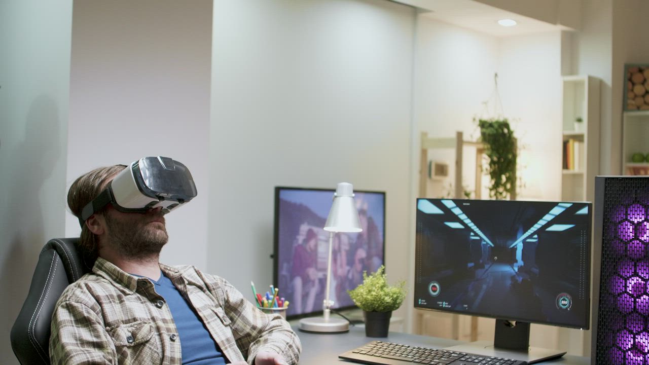 Man enjoys virtual gaming in home office - Free Stock Video