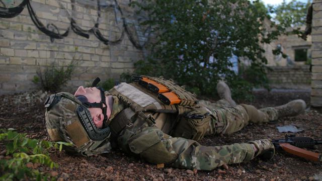 Wounded soldier being assisted.