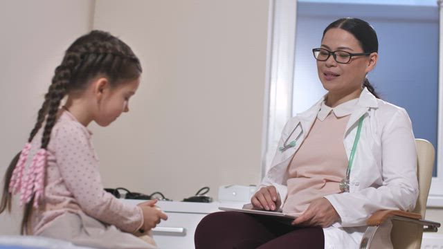 Doctor speaking with a child.