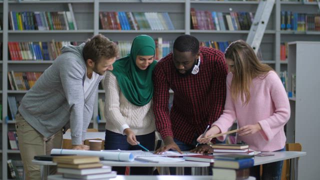 Students standing in the library.