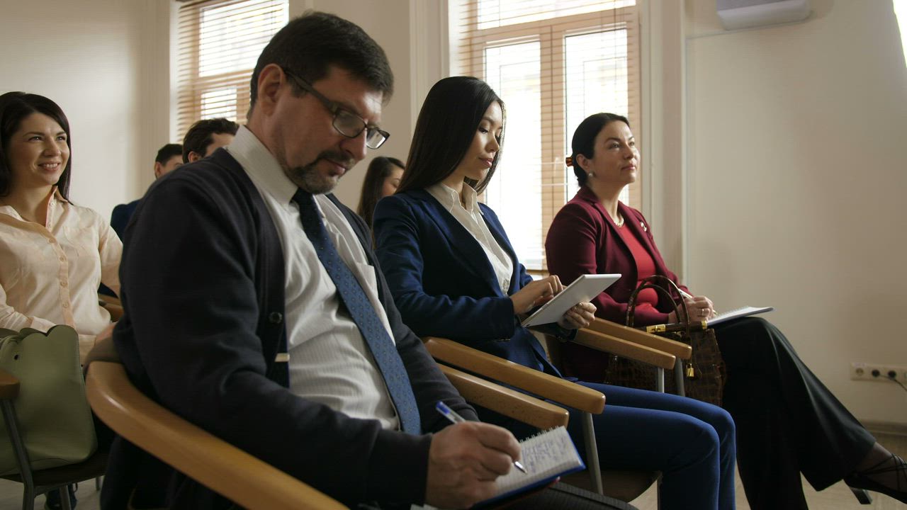 Team writing notes during a speech - Free Stock Video