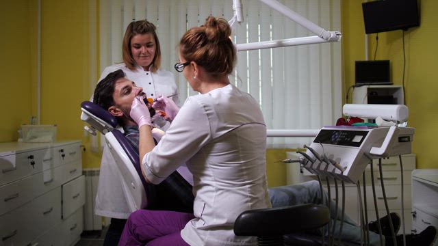Dental Nurse with a UV lamp.