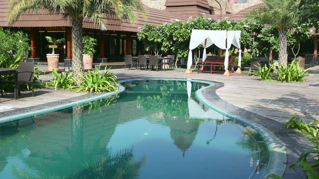 Swiming pool in resort garden.