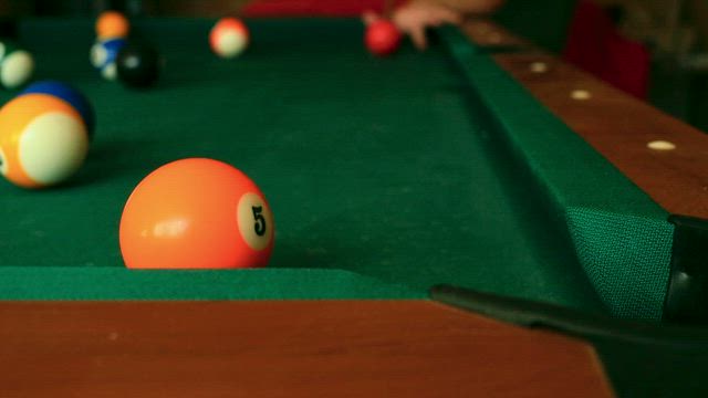 Closeup of billiard balls colliding.