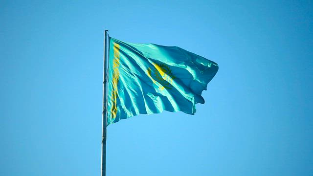 Flag waving in the clear sky.